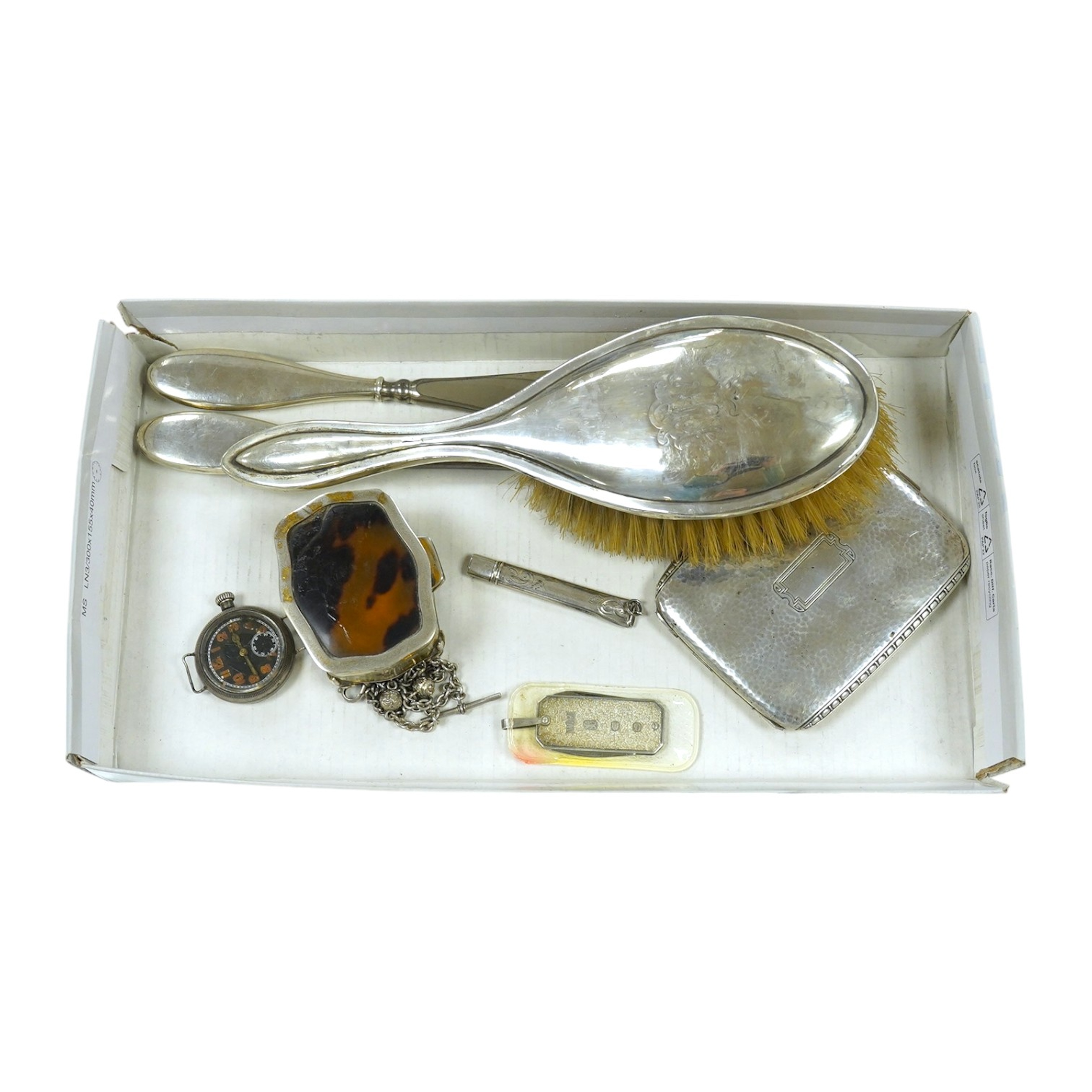 A George V silver and tortoiseshell trinket box, 6.5cm, a planished sterling cigarette case, an early silver wrist watch and sundries. Condition - fair.